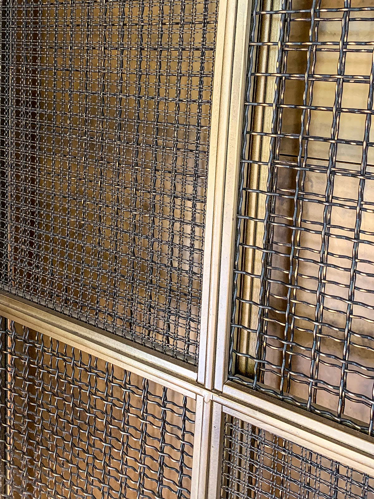 Hide Restaurant, 85 Piccadilly, London. - Exterior cladding panels to lift shaft in double layers of Amron Rigid Woven Architectural mesh M22-28 and I-188 in Antique Bronze.