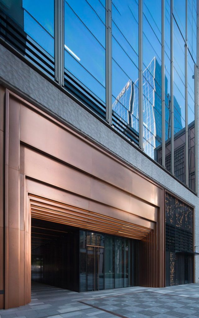Stepped door entry at the Shanghai Bund Financial Centre in PVD coloured stainless steel, Rose Gold Vibration. - Architects: Foster & Partners; Heatherwick Studio - PVD coloured stainless steel:: Double Stone Steel in partnership with John Desmond Ltd.