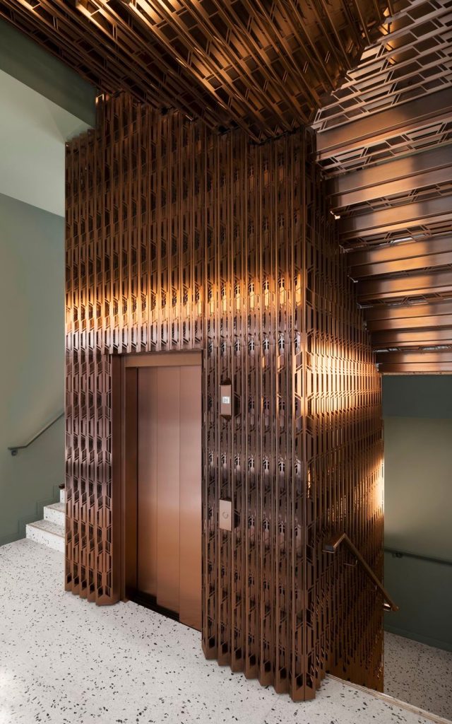 Laser-cut PVD coloured stainless steel in custom Bronze Hairline for stairs, lift core and architectural detailing. - The Gaslight Building, 29 – 35 Rathbone Street, London. - Developer: I.S.A Holdings - Interior architecture and design: bureau de change design office - Architects: dMFK Architects - PVD coloured stainless steel by Double Stone Steel in partnership with John Desmond Ltd. - Photography by Gilbert McCarragher