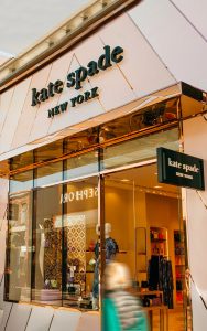 Canopy, window glazing bars and façade inset diagonal detailing in Double Stone Steel PVD coloured stainless steel Rose Gold Mirror. - Kate Spade retail store, 4525 La Jolla Village Dr Suite D27, Westfield UTC, San Diego, California.