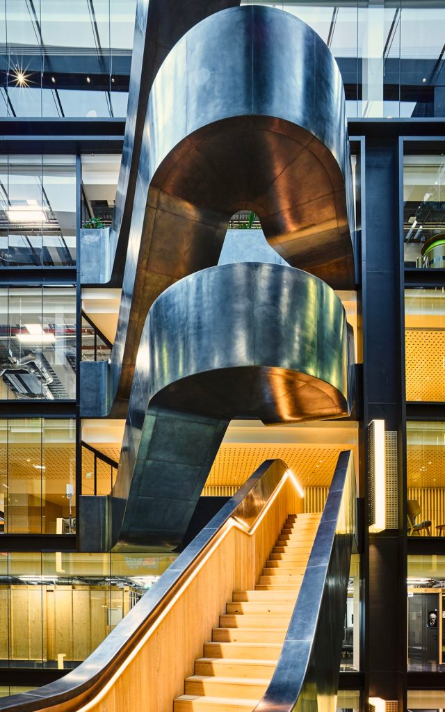 The natural waxed finish on the blackened stainless steel and the varying effects of daylight that play on it at the Google offices. - Staircase in blackened stainless steel with over-wax finish for Google, 6 Pancras Square, London, UK - Architects: AHMM - Main contractor: ISG - Staircase fabrication, installation and finishing: John Desmond Ltd - Structural engineers for John Desmond Ltd: AECOM - Photography by Tim Soar