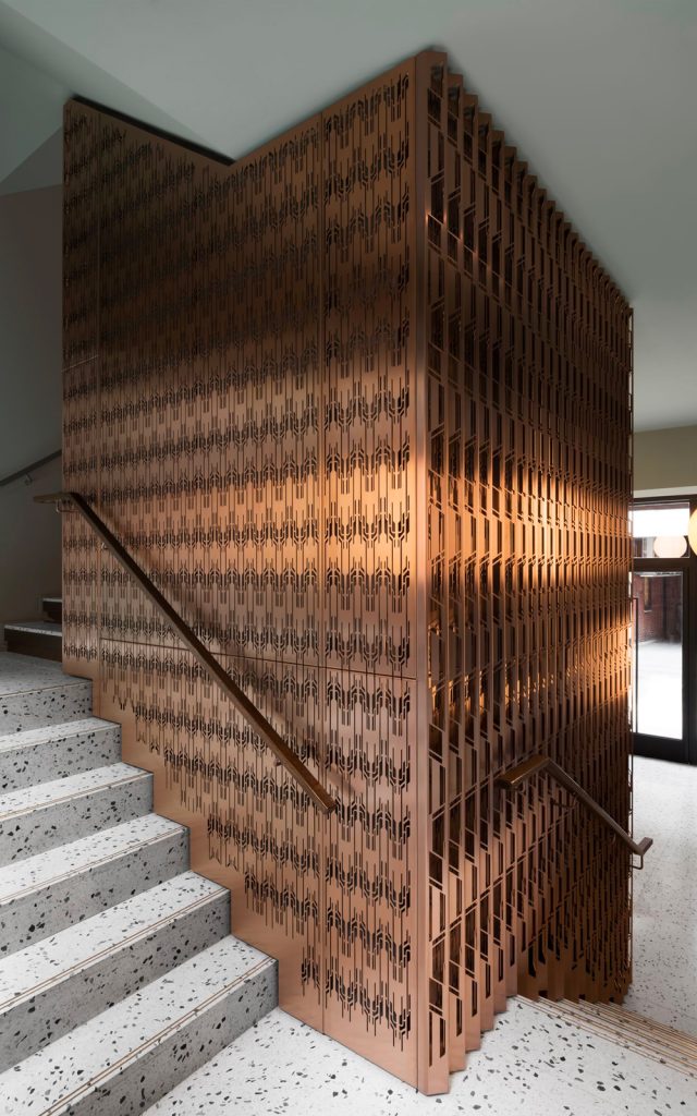 Laser-cut PVD coloured stainless steel in custom Bronze Hairline for stairs, lift core and architectural detailing. - The Gaslight Building, 29 – 35 Rathbone Street, London. - Developer: I.S.A Holdings - Interior architecture and design: bureau de change design office - Architects: dMFK Architects - PVD coloured stainless steel by Double Stone Steel in partnership with John Desmond Ltd. - Photography by Gilbert McCarragher