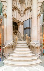 Staircase Balustrade and handrail in PVD coloured stainless steel in Almond Gold Vibration. - The Royal Exchange retail atrium, London EC3V 3LR - Architect: Aukett Swanke- Staircase specialist: Alpine Group - PVD coloured stainless steel: John Desmond Ltd.