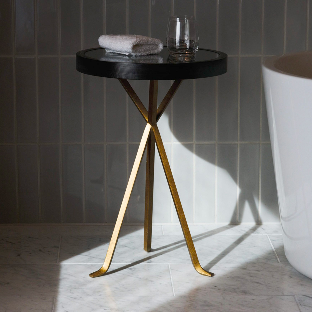 A bespoke side table with legs in flattened bar material for a hotel bathroom, base in PVD coloured stainless steel in Brass by John Desmond Ltd.