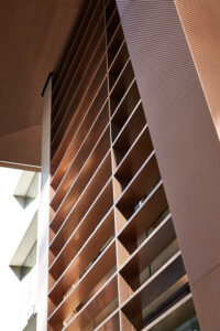 Looking up at the hollow canopy which, using V-Grooved PVD coloured stainless steel, has been folded to look as if it were solid bronze.